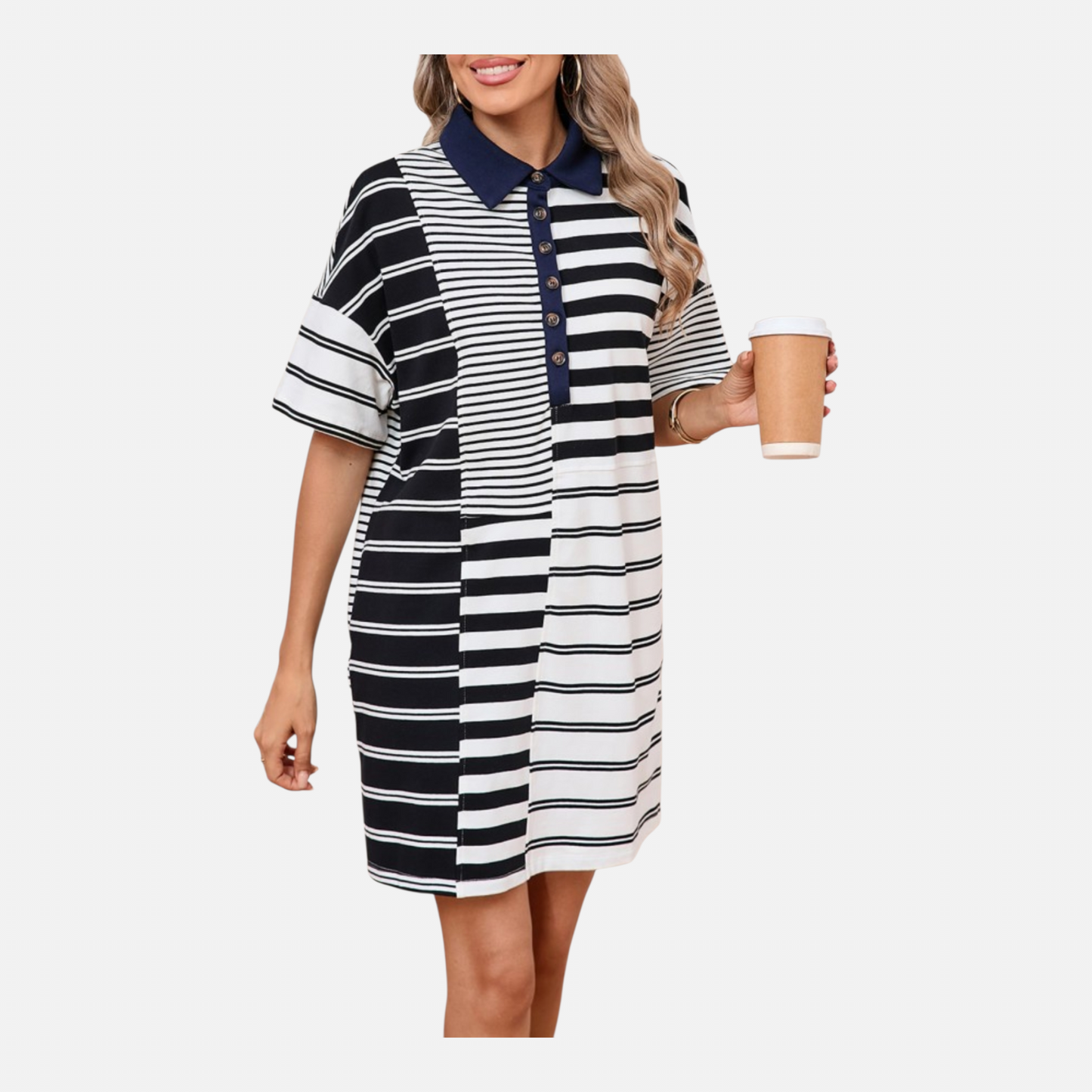 Woman wearing a black and white striped dress holding a coffee cup on a white background