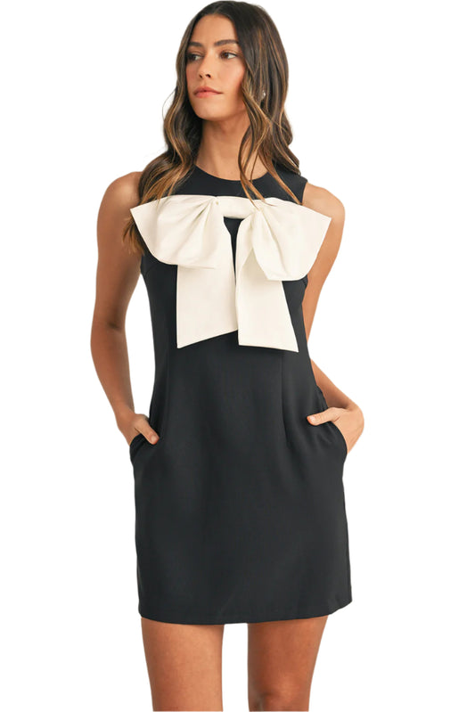 Black mini dress with bow print at front.