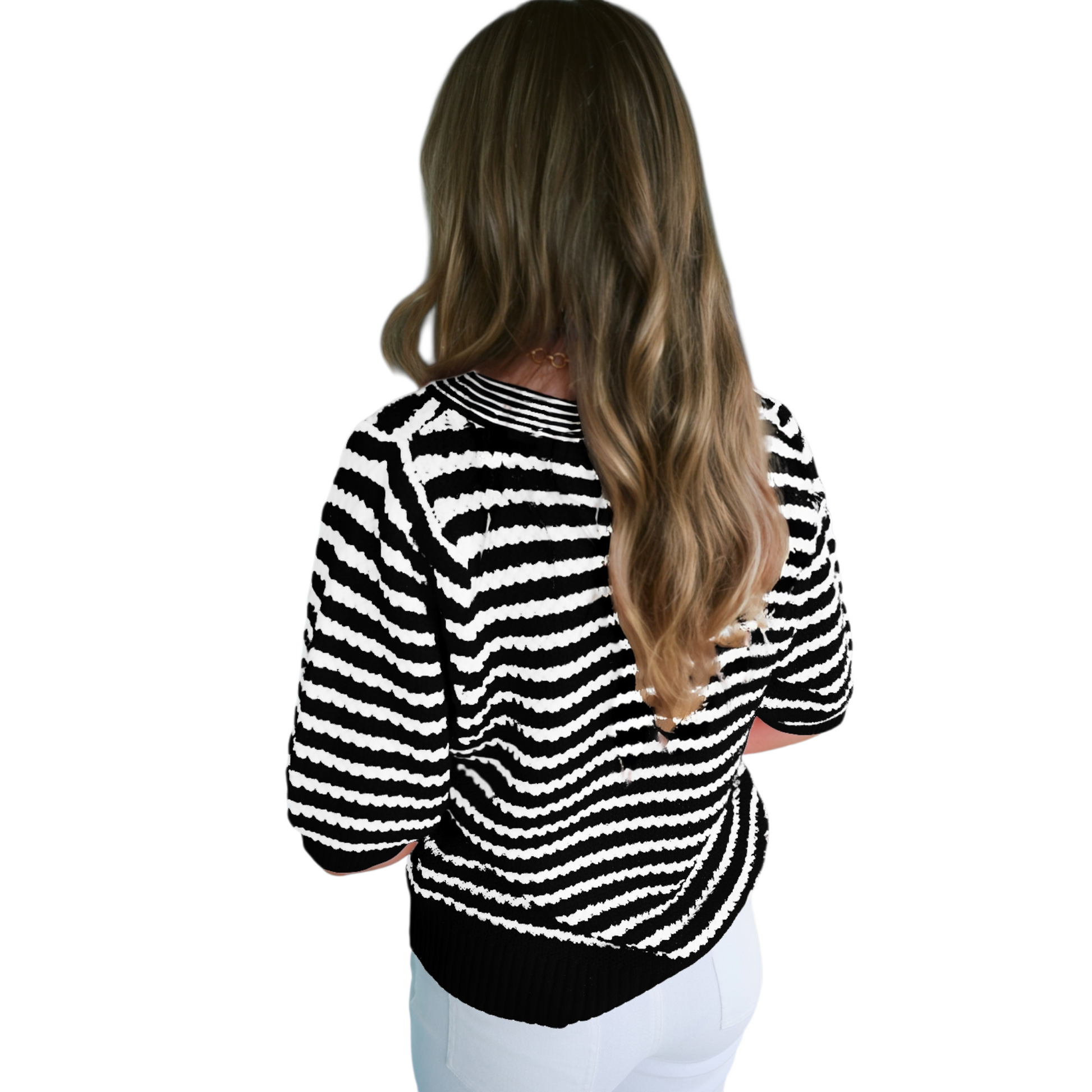 Rear view of a black and white striped textured knit sweater showing the seamless pattern and ribbed hemline.