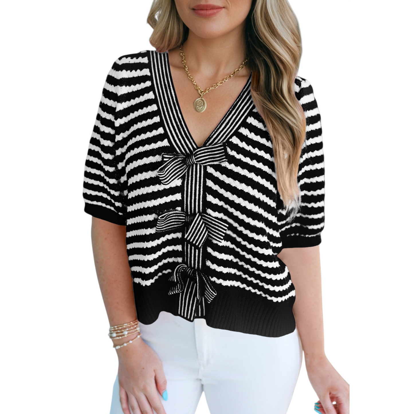 Front view of a black and white striped textured knit sweater showing the seamless pattern and ribbed hemline.