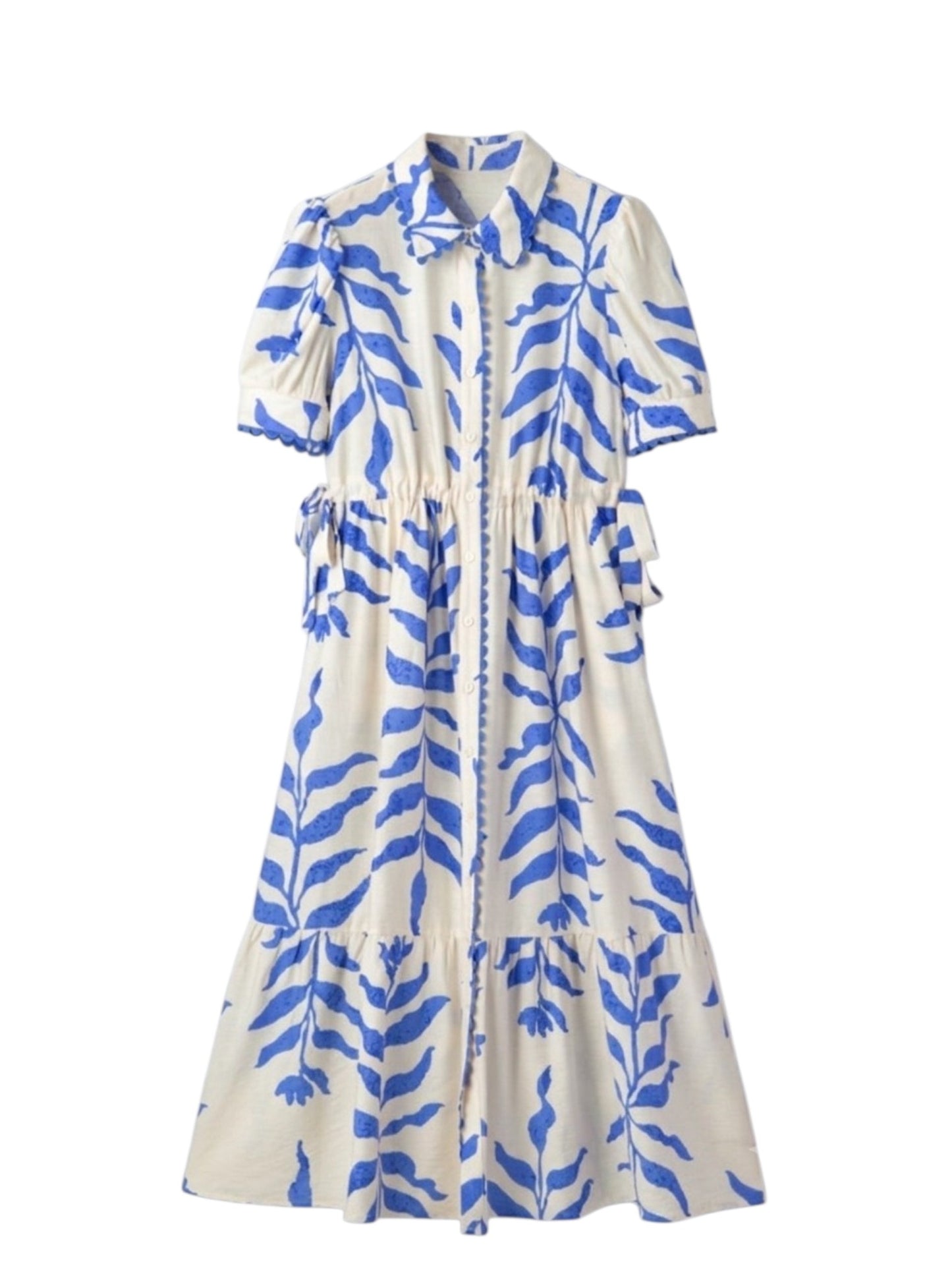 A short-sleeve midi dress with a blue botanical leaf print on a cream background, featuring a pointed collar, button-front closure, and side tie details.