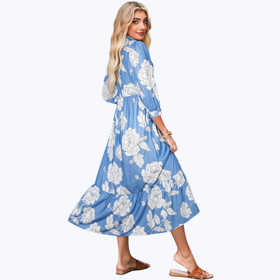 Woman wearing a blue floral dress on a white background
