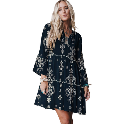 Woman wearing a navy blue dress with white patterns on a white background