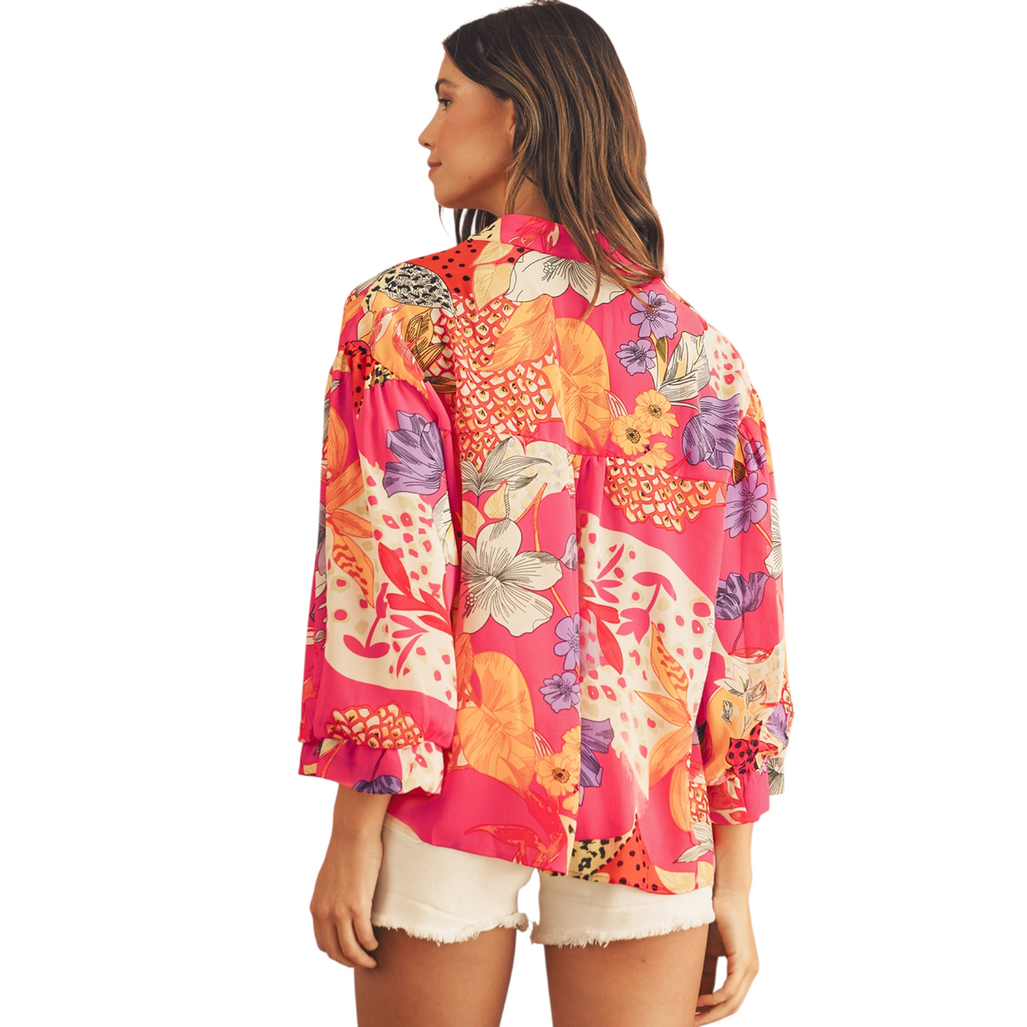 Woman wearing a colorful floral and animal print shirt on a white background. Back view photo shot.