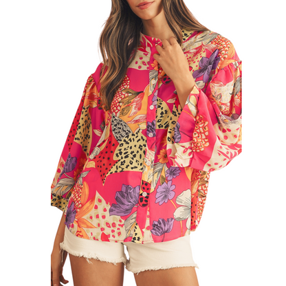 Woman wearing a colorful patterned shirt on a white background