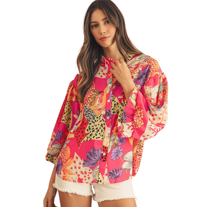 Woman wearing a colorful floral shirt on a white background