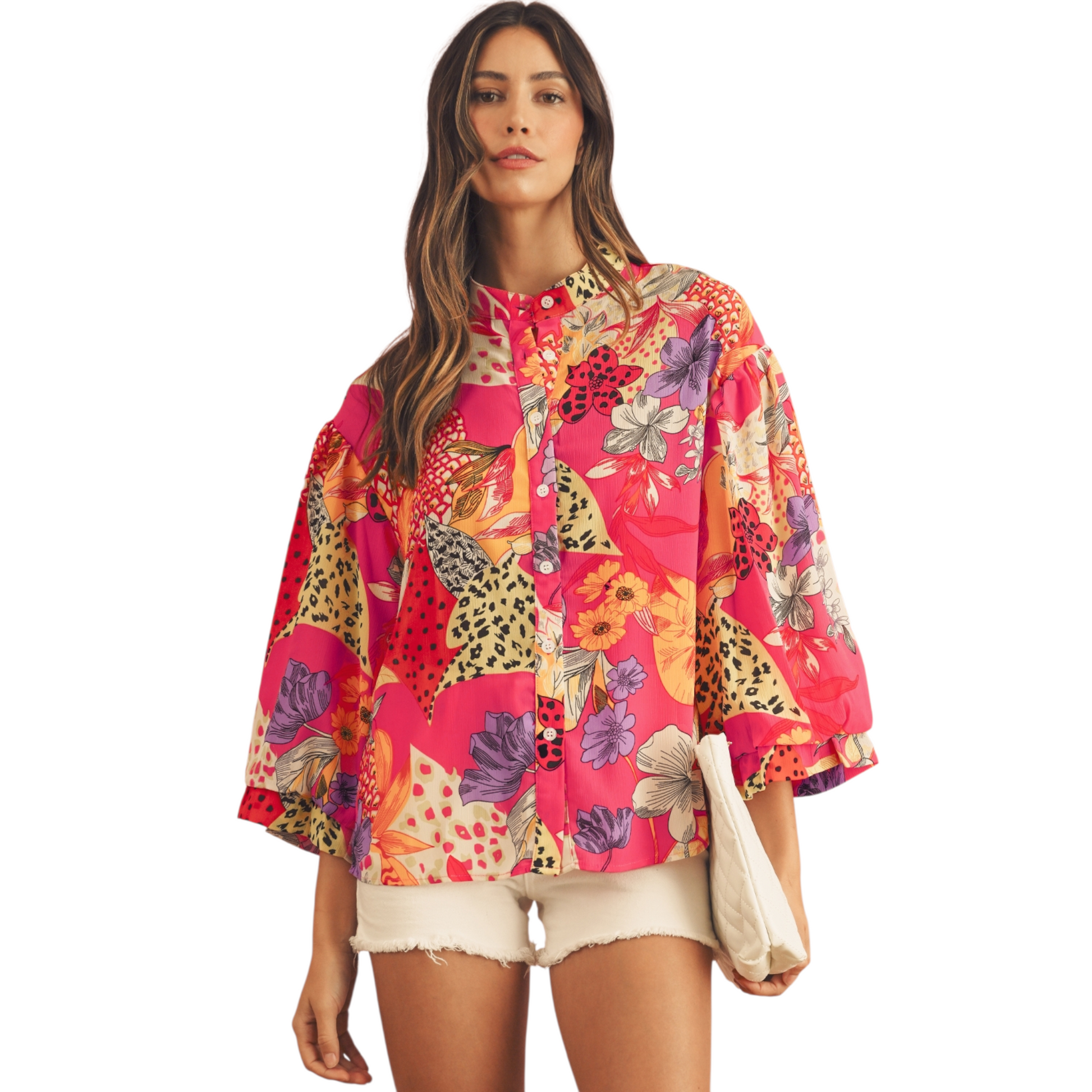 Woman wearing a colorful floral and animal print shirt on a white background