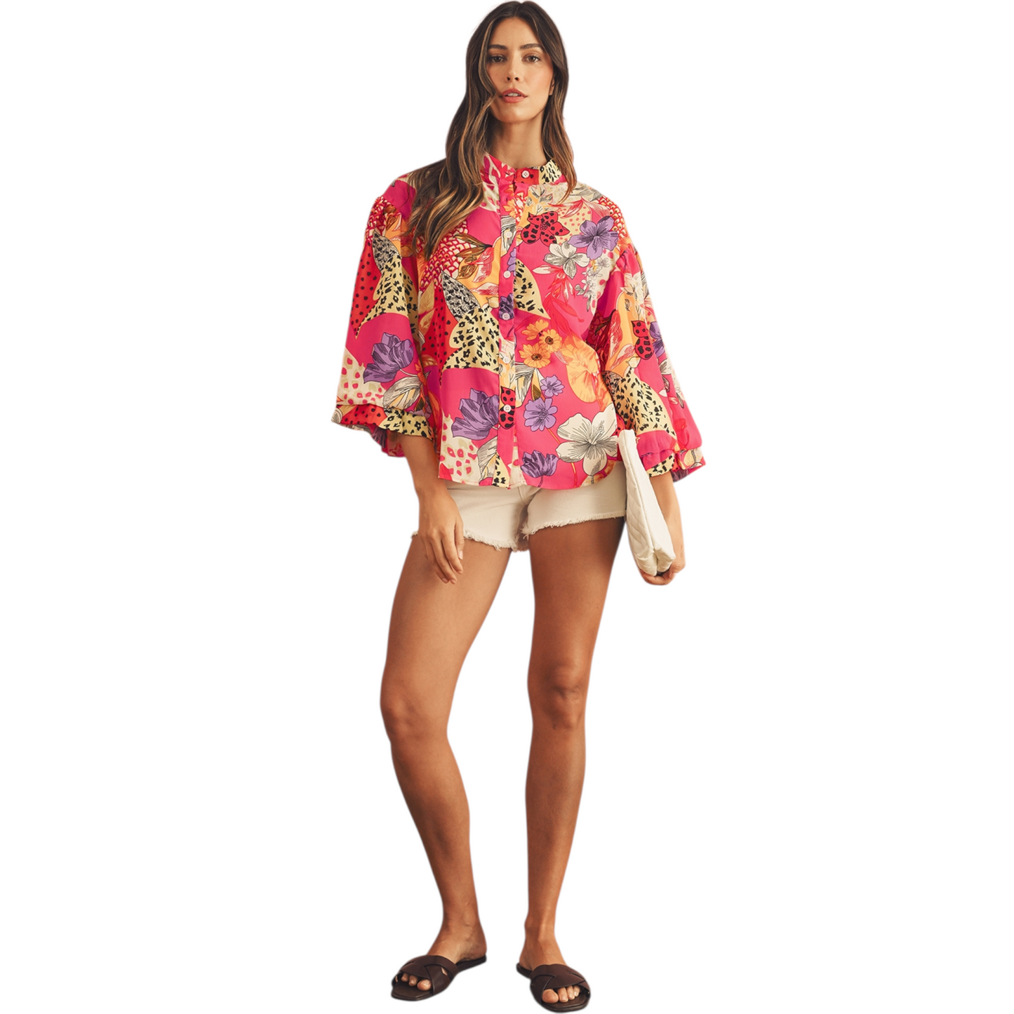 Woman wearing a colorful floral and animal print shirt on a white background