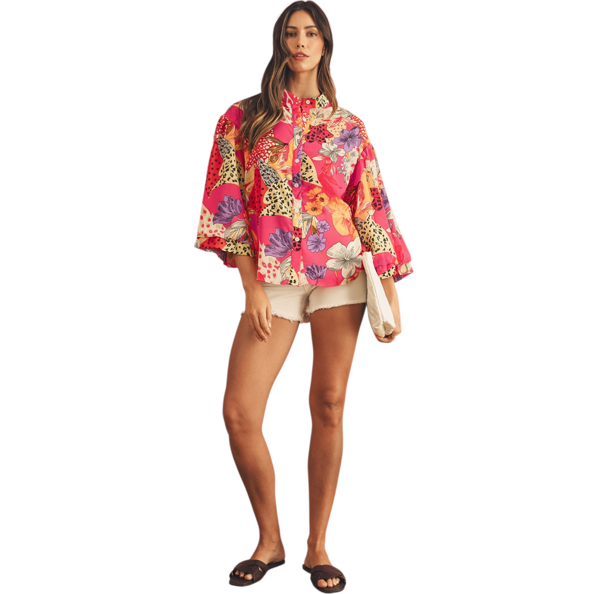 Woman wearing a colorful floral and animal print shirt on a white background