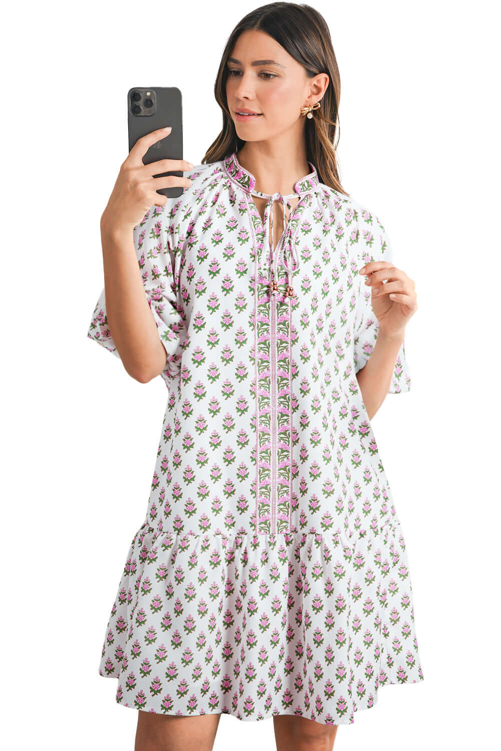 Romantic pink floral dress featuring bishop sleeves and a flowy ruffle hem for a chic, bohemian look.