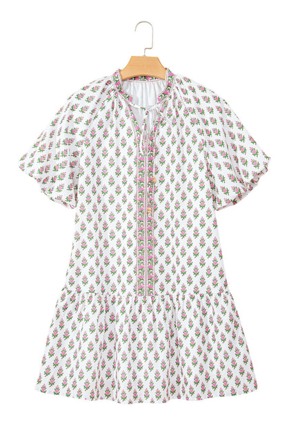 Pink floral dress with adjustable drawstring waist and lightweight polyester fabric on a hanger.