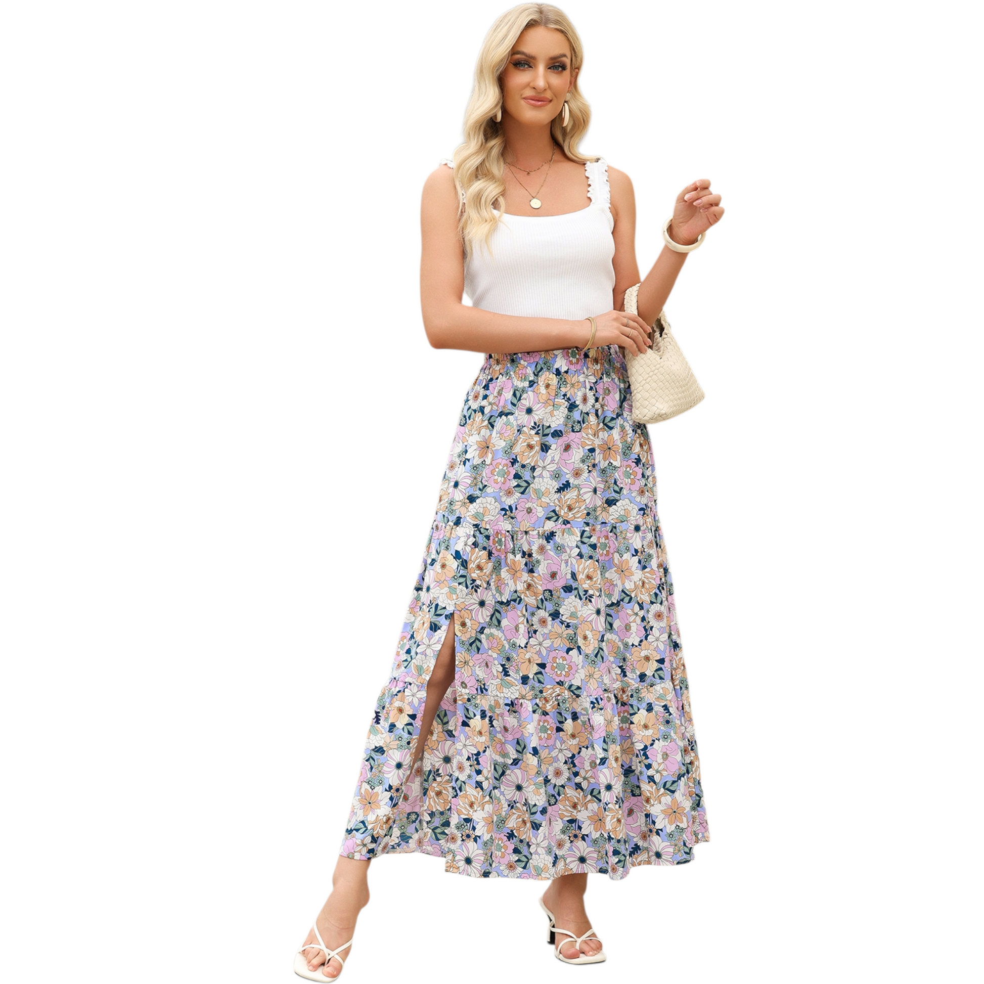 A woman wearing a lightweight, tiered floral maxi skirt in shades of purple and pink with a high side split and elasticated waist.