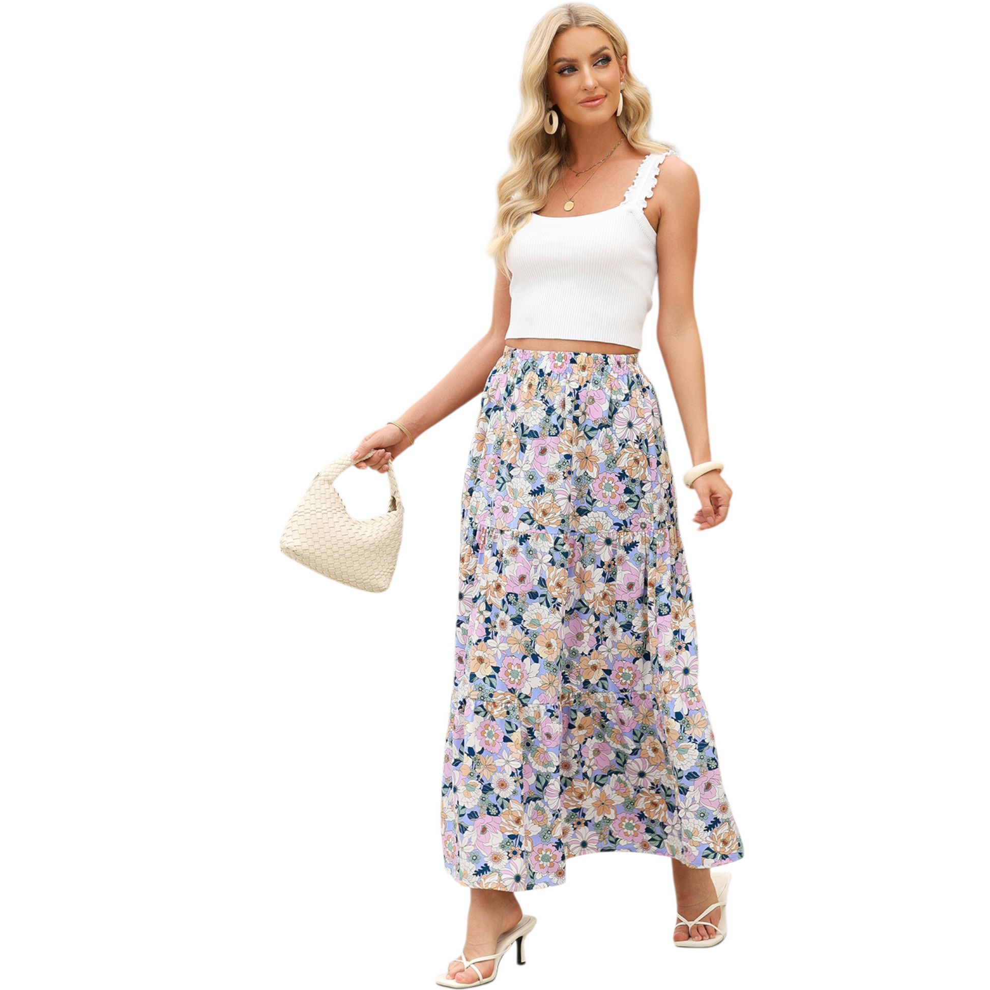 A woman wearing a lightweight, tiered floral maxi skirt in shades of purple and pink with a high side split and elasticated waist.