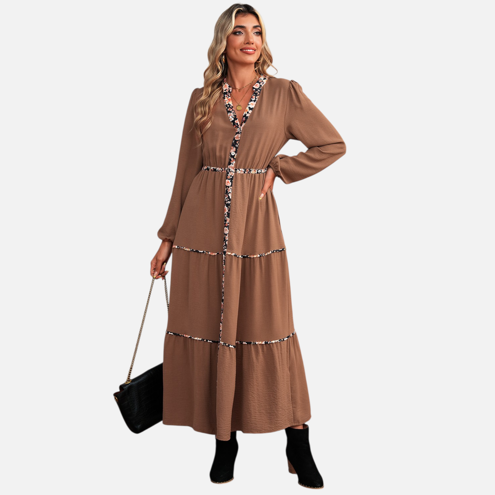 Full-body view of a model in a brown bohemian maxi dress with tiered skirt and floral-accented trim, perfect for elevated daywear.