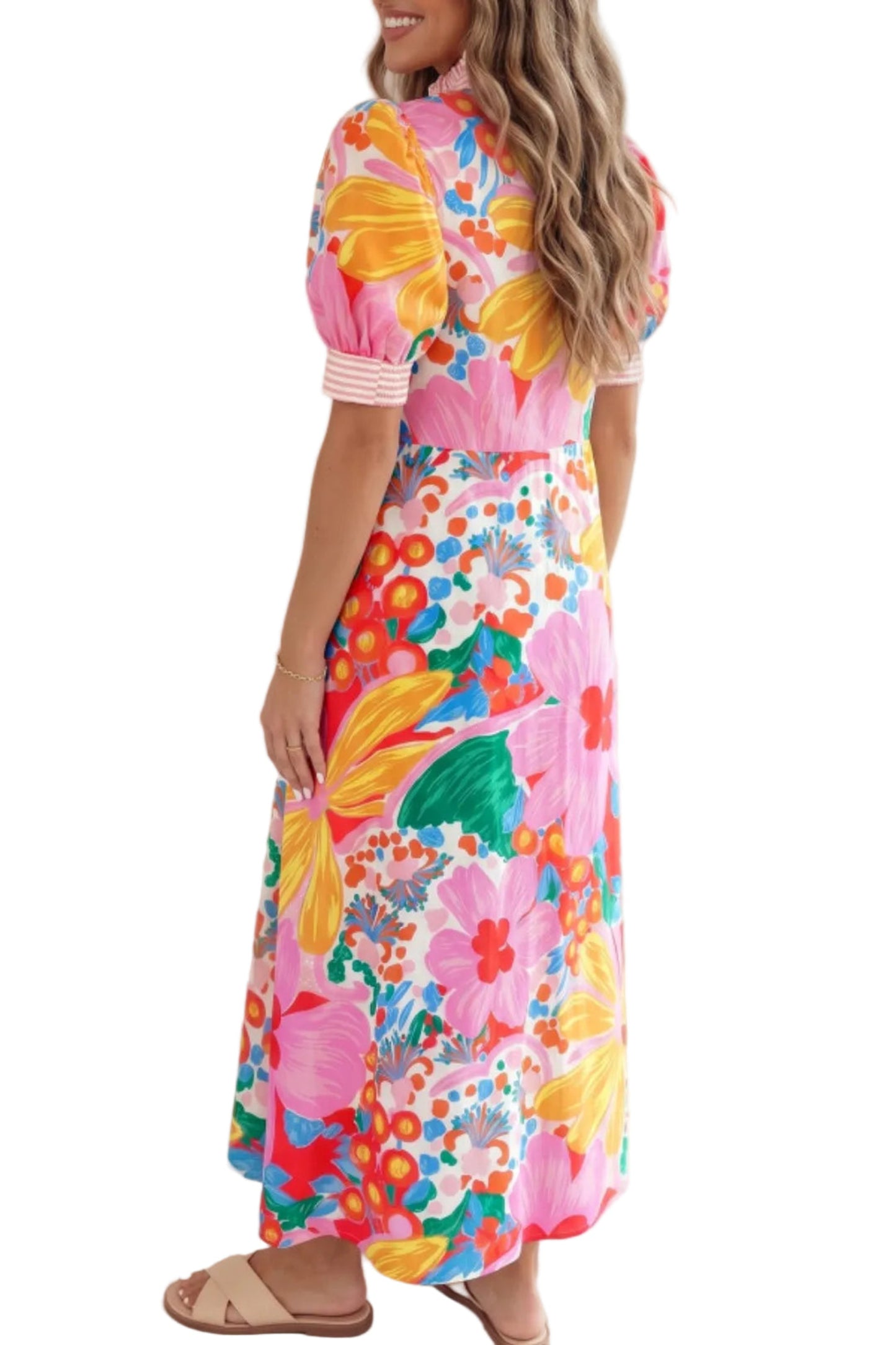 Woman wearing a colorful floral dress standing against a white the background back profile view
