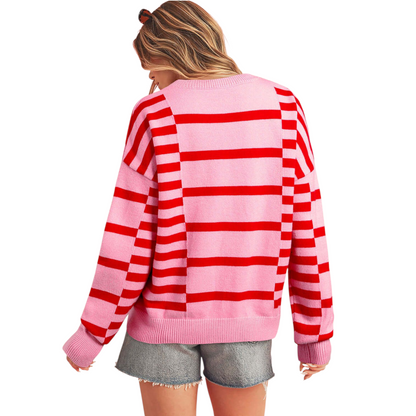 Person wearing a pink and red striped sweater on a white background