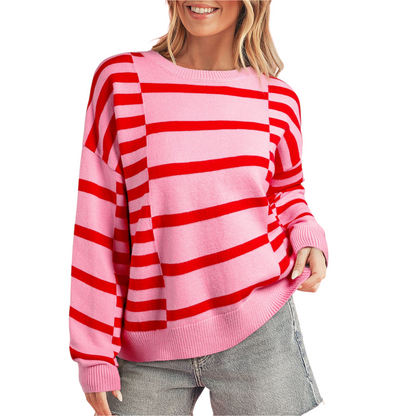 Person wearing a pink and red striped sweater on a white background