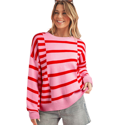 Woman wearing a pink and red striped sweater on a white background