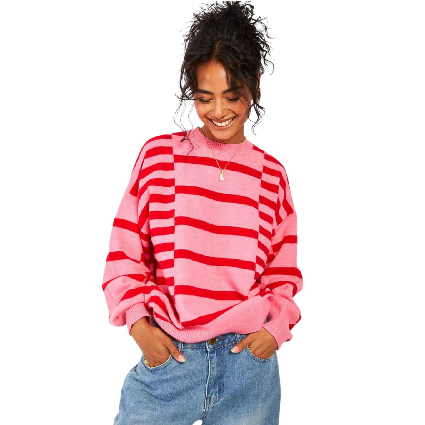 Person wearing a pink and red striped sweater with blue jeans on a white background