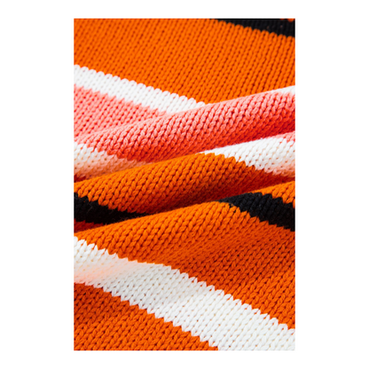 Close-up of a fabric with orange, white, and black stripes.