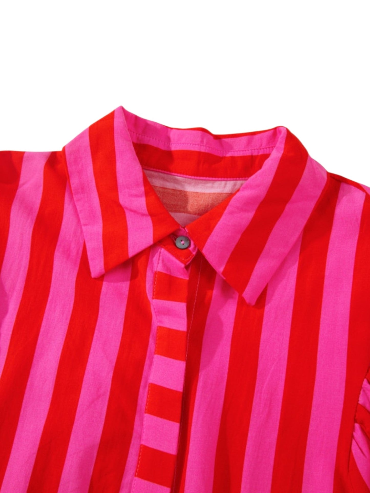 Close-up of a red and pink striped shirt with collar on a white background