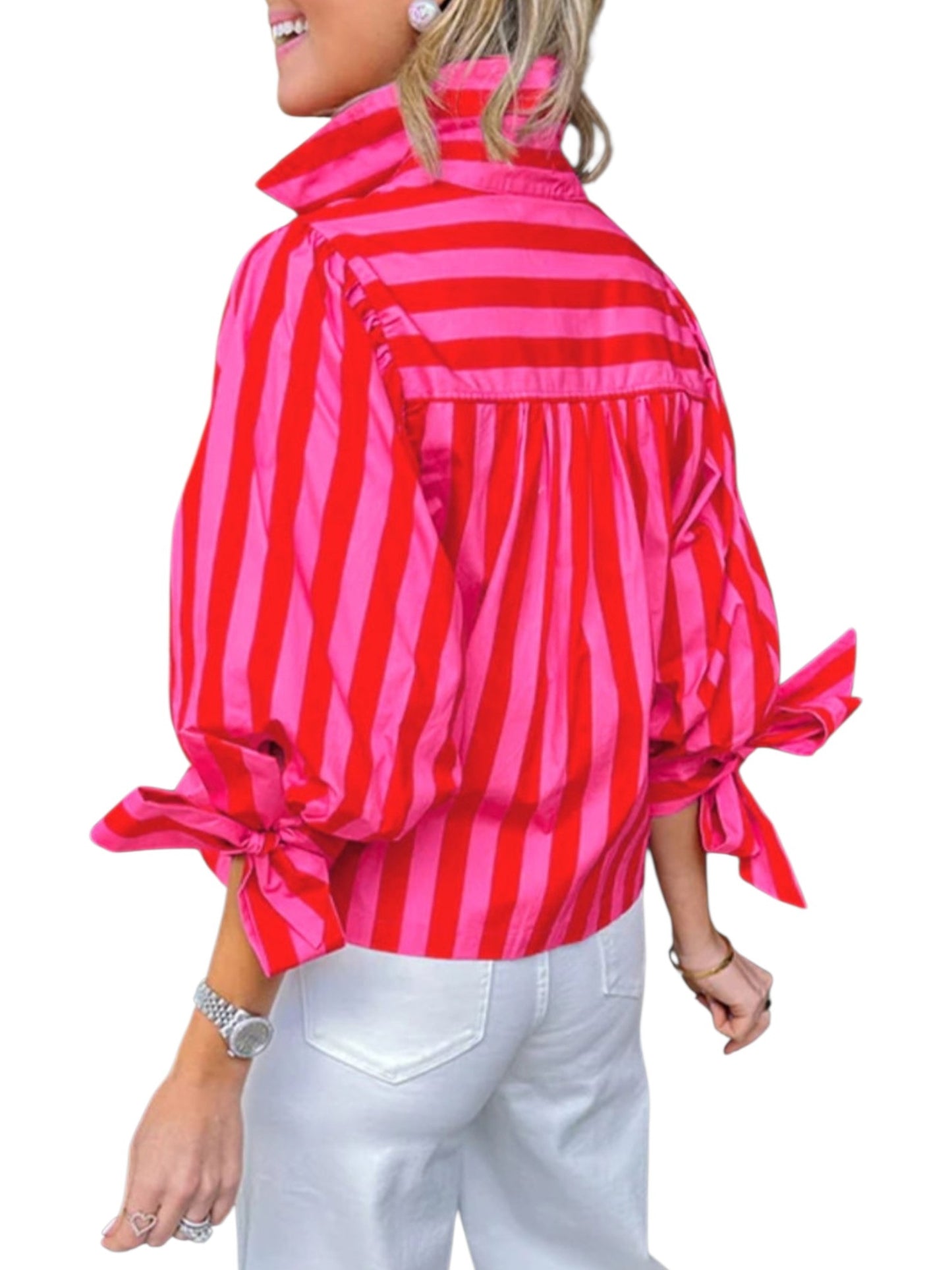 Person wearing a red and pink striped shirt with a bow detail on a white background