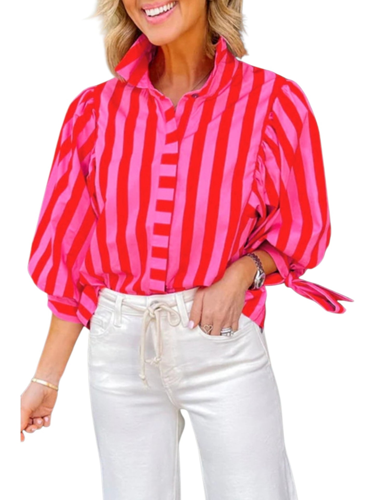 Woman wearing a red and pink striped blouse with white pants on a white background