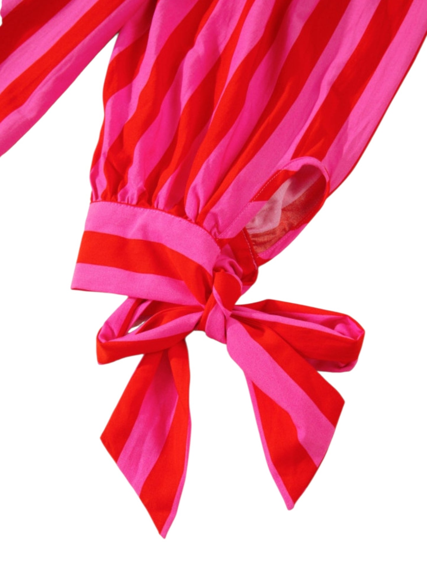 Red and pink striped fabric with a bow on a white background