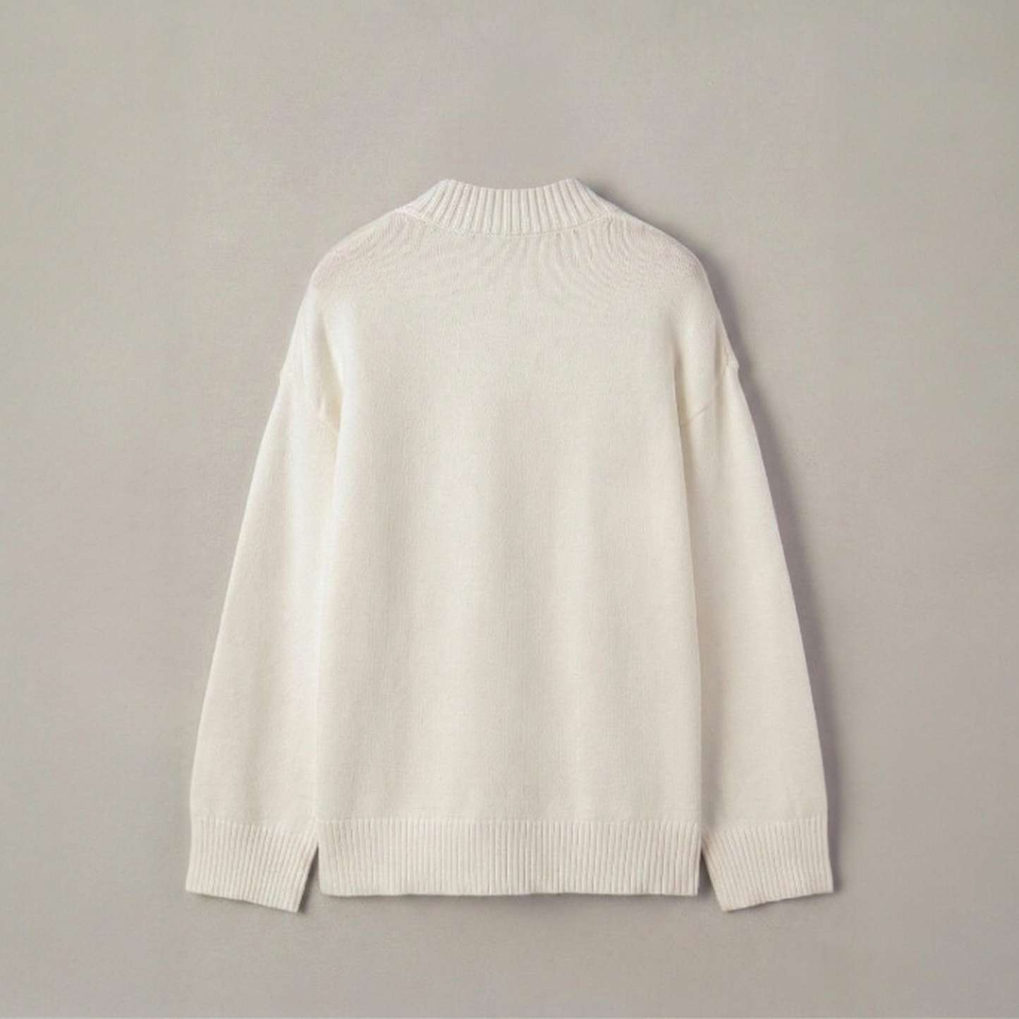 Back view of a plain white knit sweater with a ribbed crew neckline, displayed on a wooden hanger.
