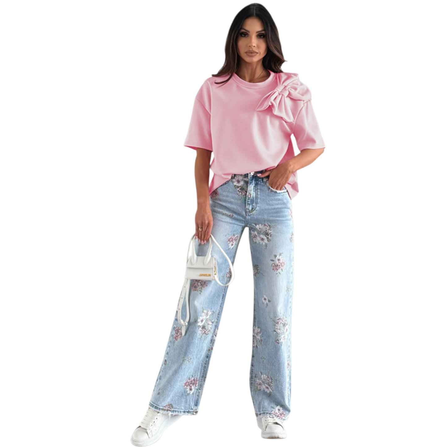 A woman wearing a vibrant pink t-shirt with a large decorative bow applique on the shoulder and relaxed drop sleeves.