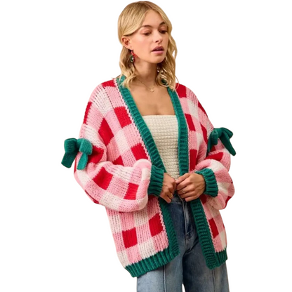 Woman wearing a colorful checkered cardigan with green accents on a white background