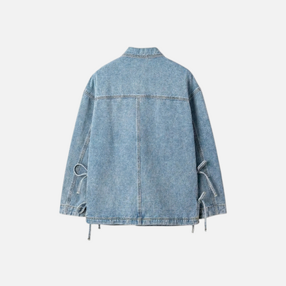 Rear flat lay of a light-wash denim boyfriend jacket, showing the side tie-up strings and classic denim stitching.