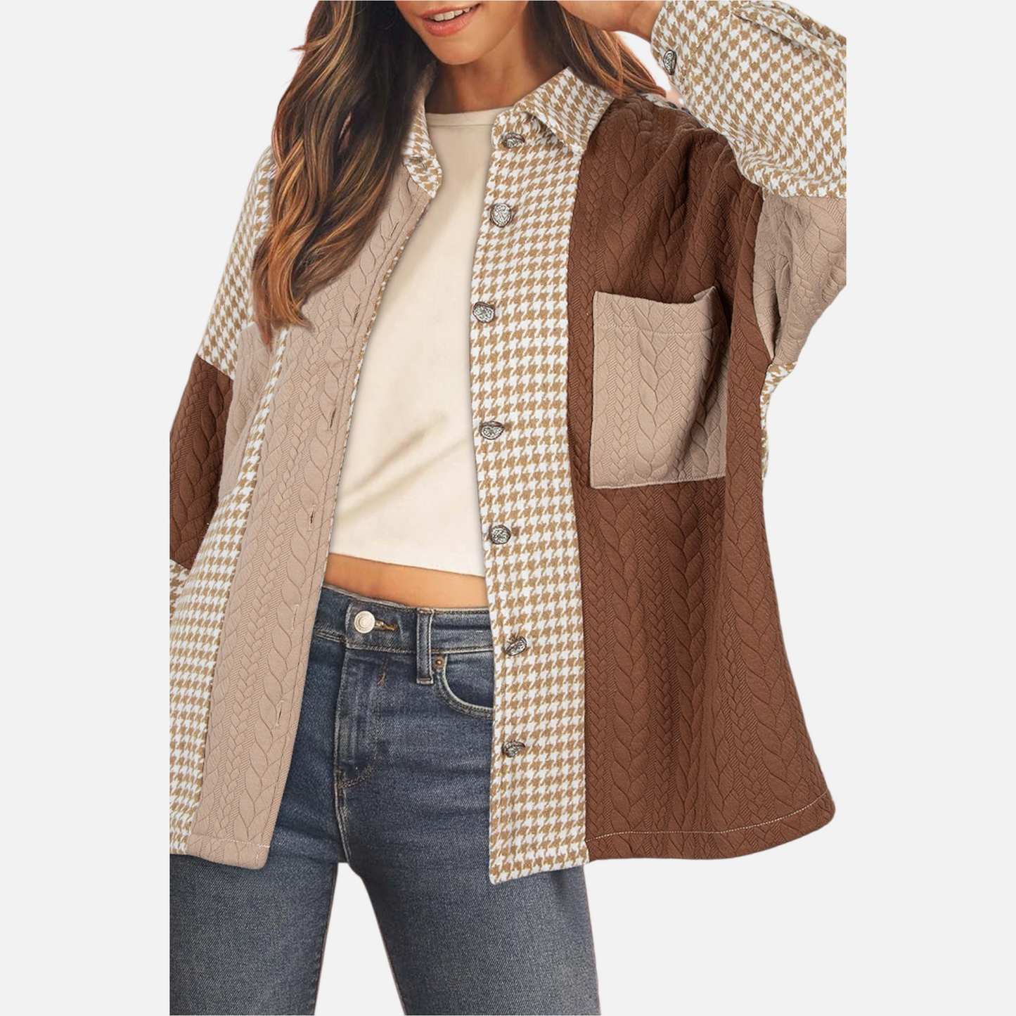 Close-up view of a model showcasing the detailed textures of the brown patchwork shacket, highlighting the blend of houndstooth patterns and beige and brown cable-knit panels.