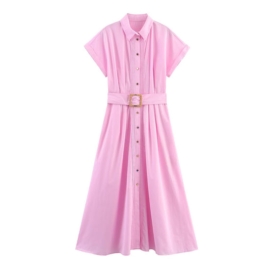 A full front view of a bubblegum pink long shirt dress featuring a collared neckline, short sleeves, and a matching belt with a woven straw buckle.