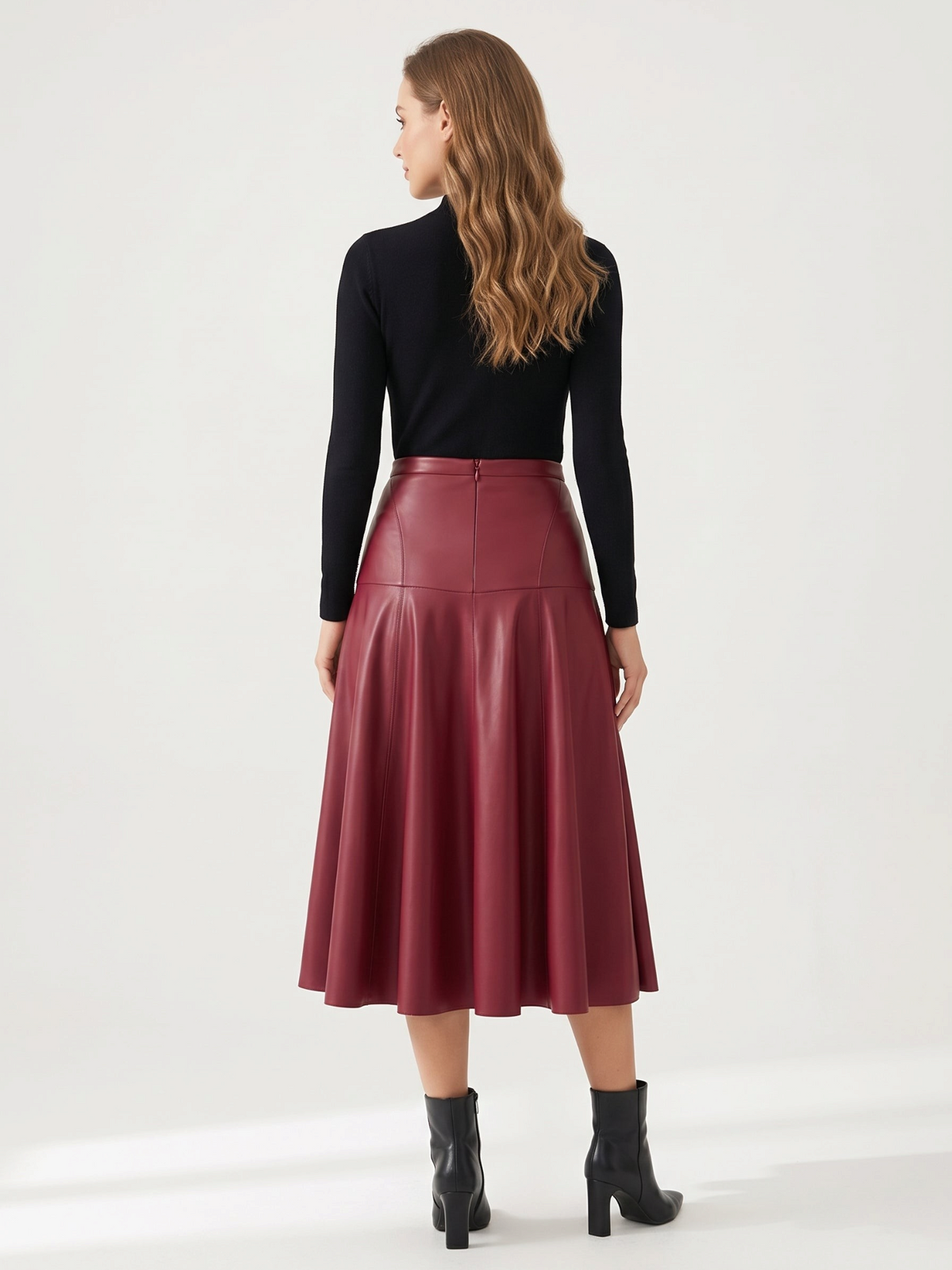 Catherine Martin burgundy faux leather midi skirt with high waist and flared A-line silhouette, back view.