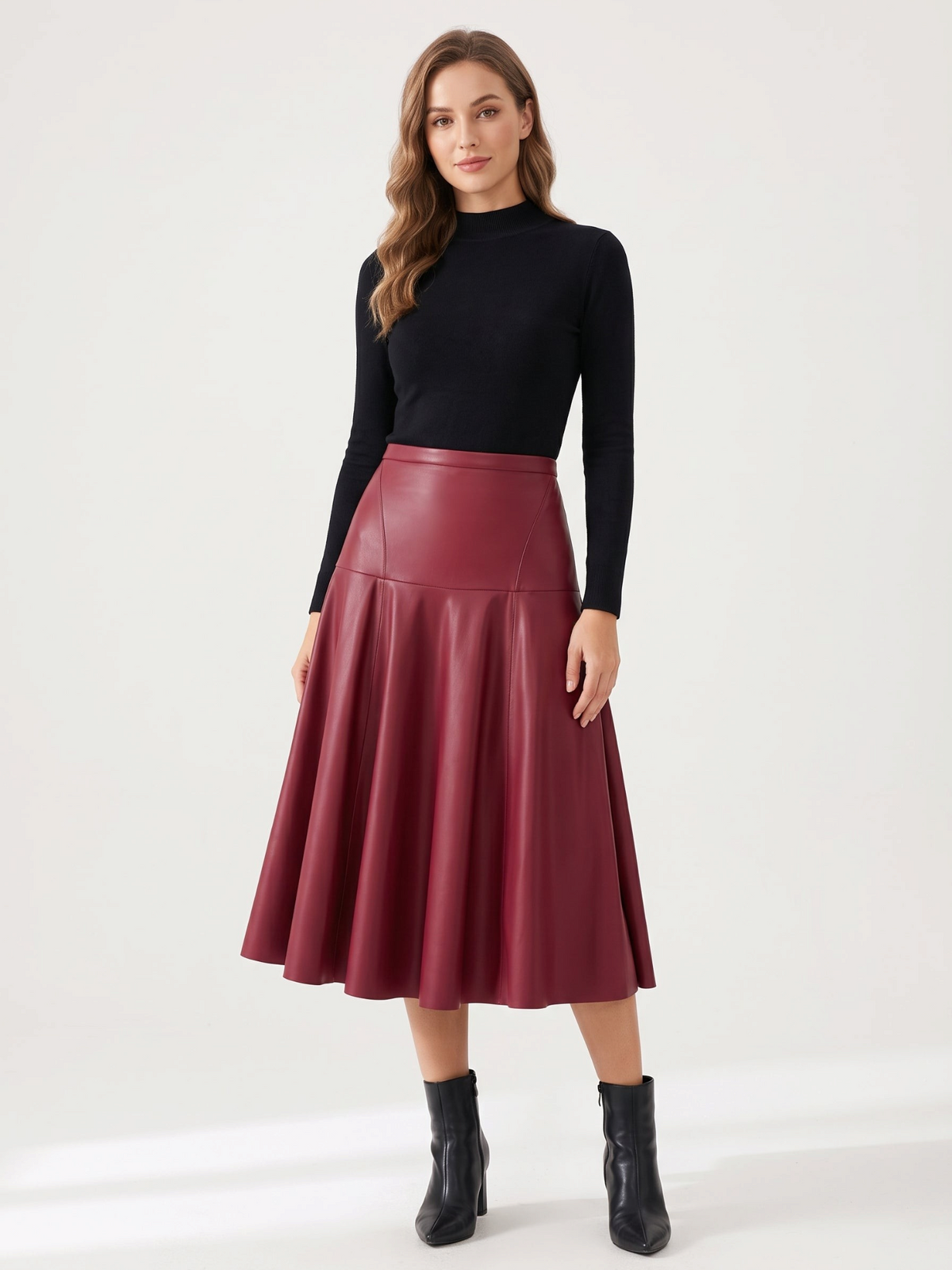 Model wearing a Catherine Martin burgundy faux leather midi skirt with a high-waisted flared A-line silhouette.