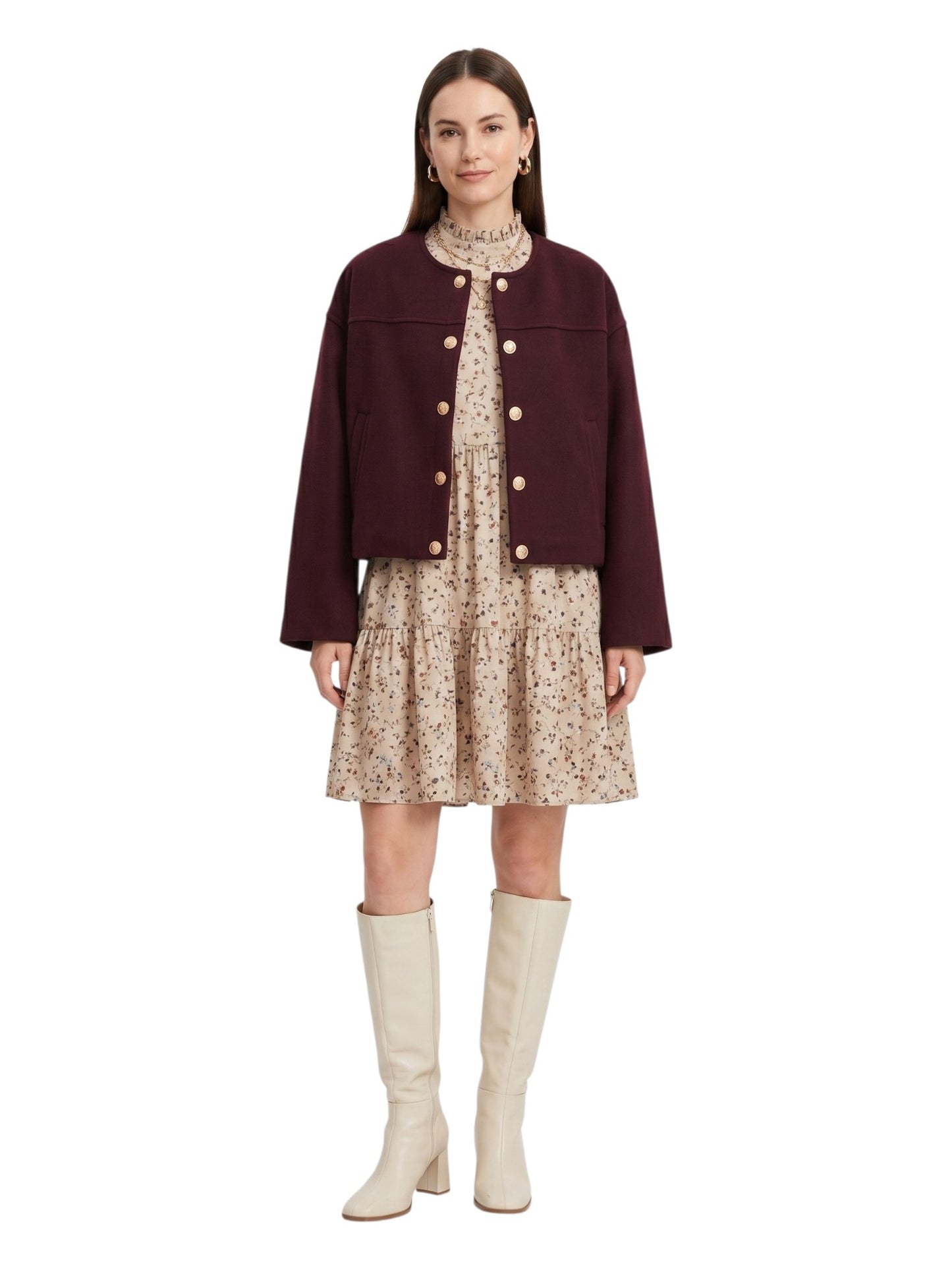 Full-length front view of a model styling a burgundy wool-look cropped jacket with a floral mini dress and cream knee-high boots.