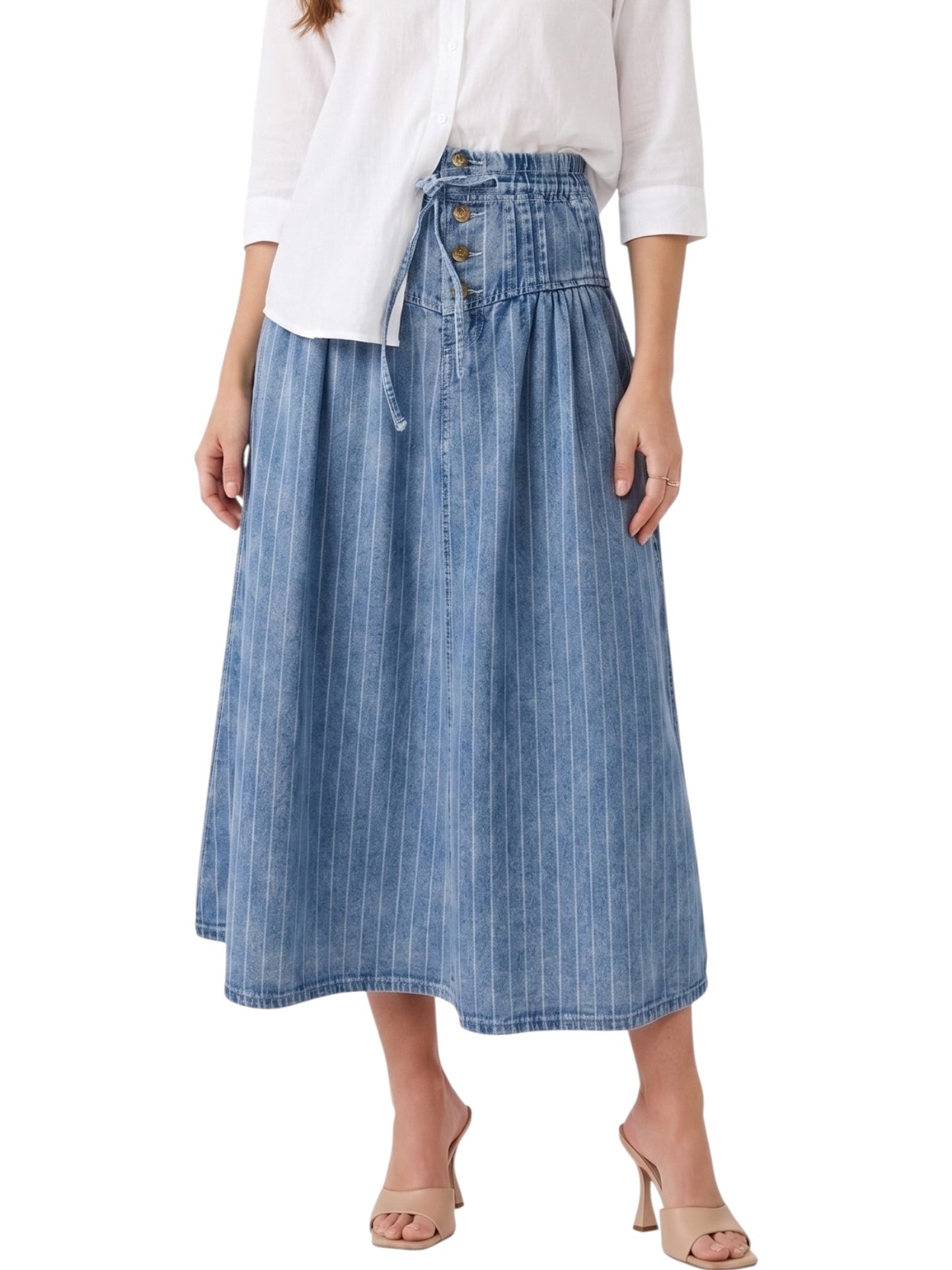 Person wearing a blue denim skirt with a white top on a white background