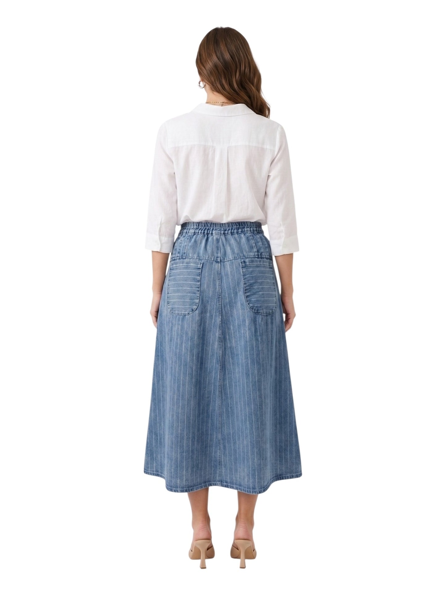 Woman wearing a white blouse and blue denim skirt on a white background