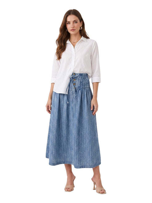 Woman wearing a white blouse and blue denim skirt on a white background