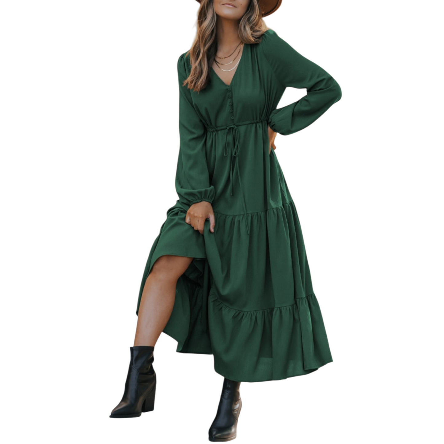 Woman in a green, long-sleeve, tiered maxi dress with a V-neckline and drawstring waist, paired with black ankle boots