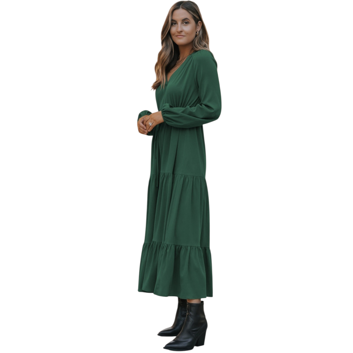 Woman in a green, long-sleeve, tiered maxi dress with a V-neckline and drawstring waist, paired with black ankle boots