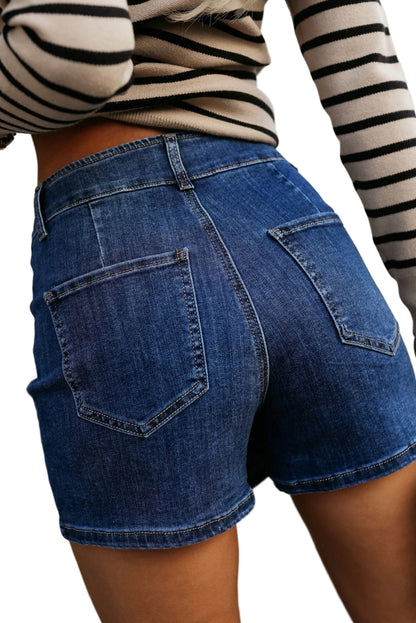 Person wearing blue denim shorts and a striped long-sleeve shirt.