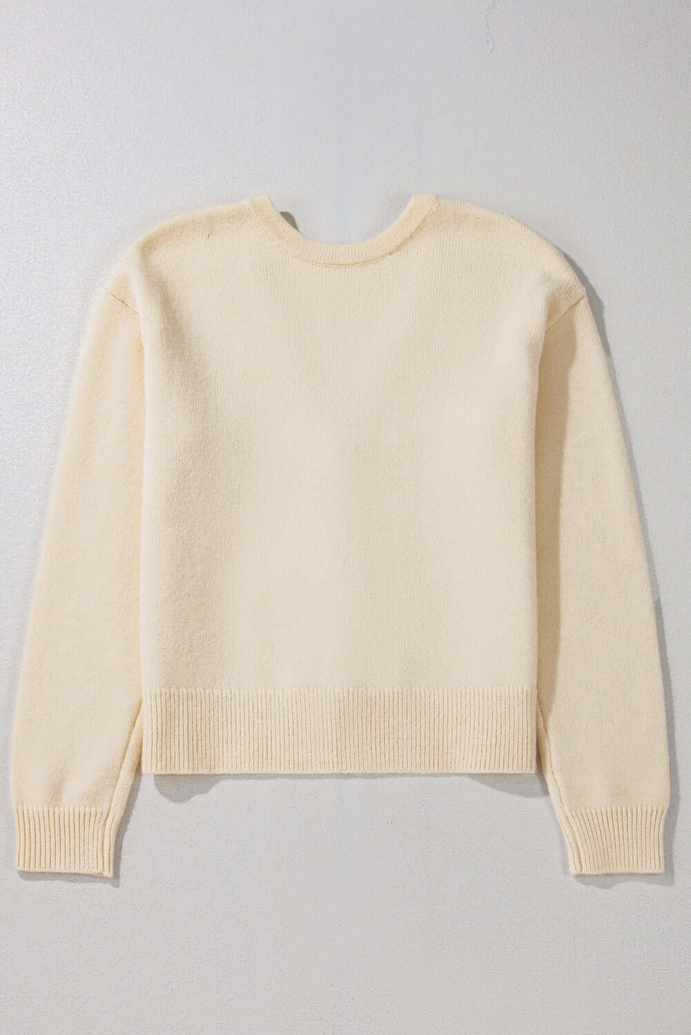 Back view of a soft V-neck cardigan, showcasing its relaxed and cosy fit.

