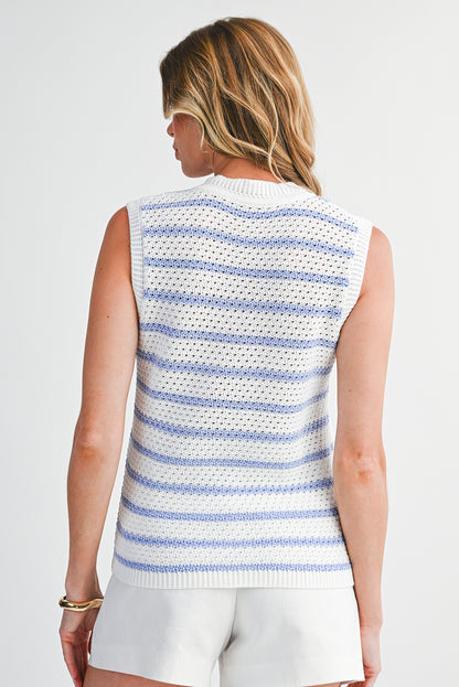 Woman wearing a sleeveless striped sweater on a plain background