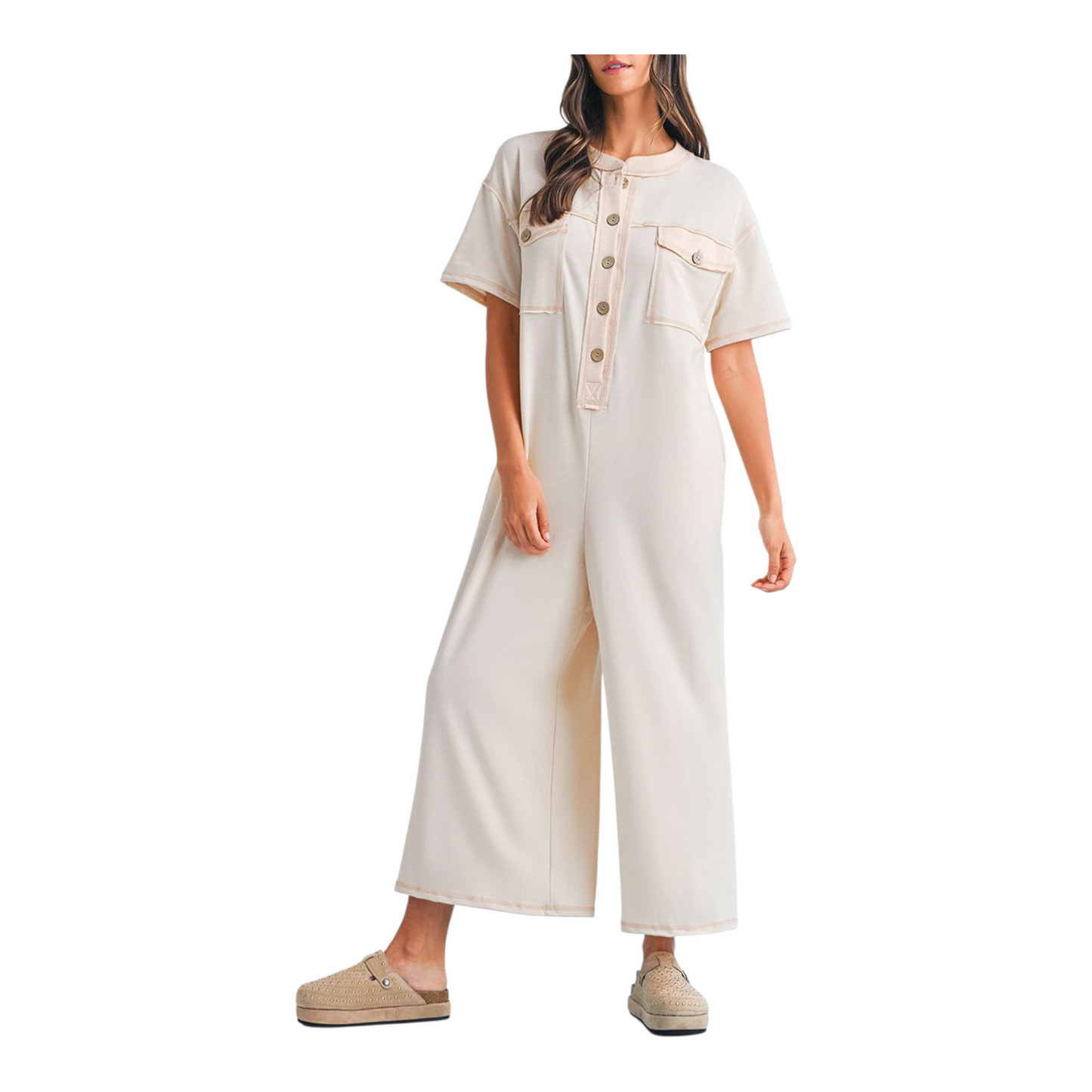 Woman wearing a beige jumpsuit on a white background