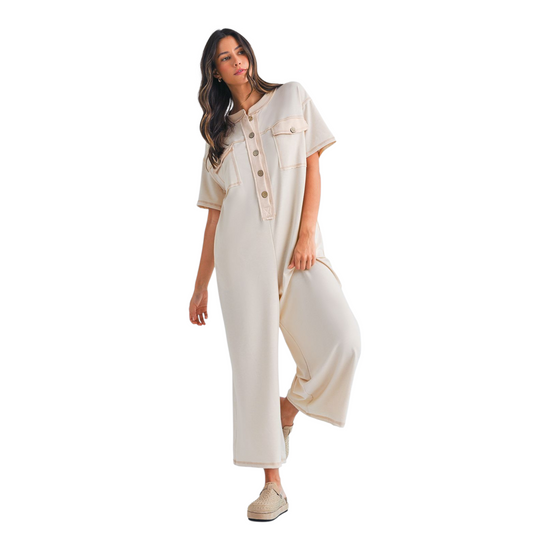 Woman wearing a beige outfit with a white background