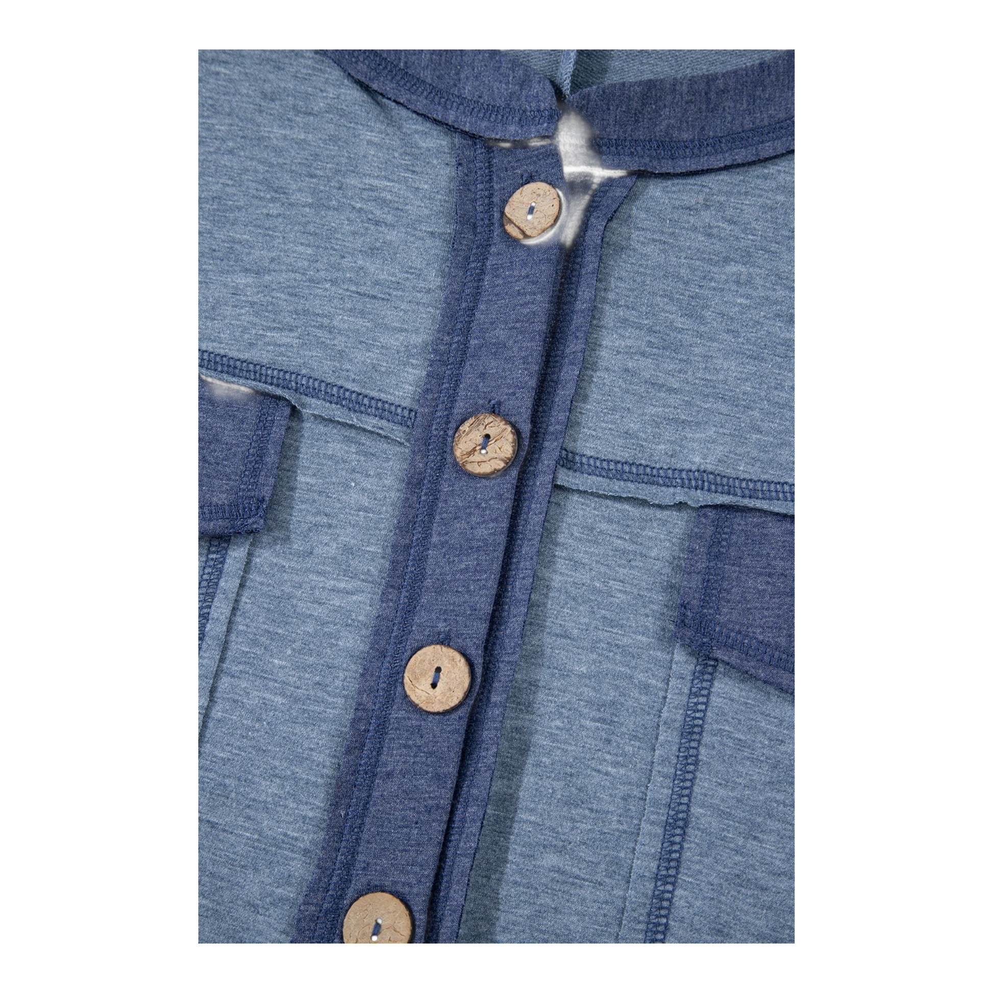 Close-up of a blue garment with wooden buttons
