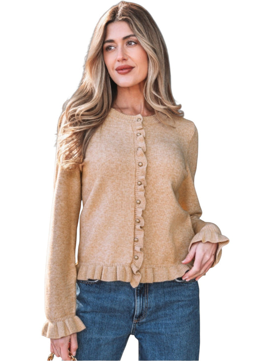 Catherine Martin beige knit cardigan featuring ruffle trim, gold buttons, and long sleeves worn with blue jeans