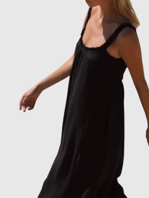 Catherine Martin black linen and cotton maxi dress with frayed raw edges and a scoop neckline on a model